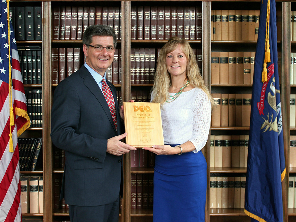 Two people holding award