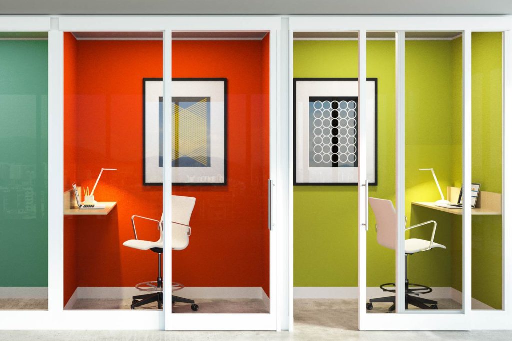 The image shows colorful workstations that are using a simple, single arm desk light for illumination.