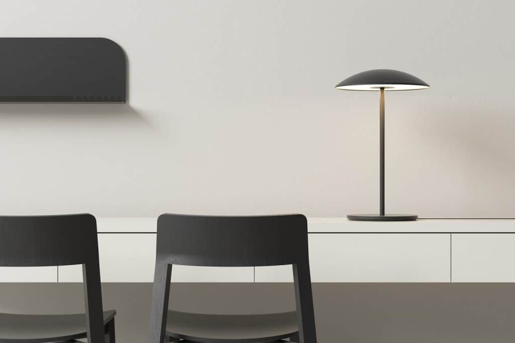 A desk with a black pendant light